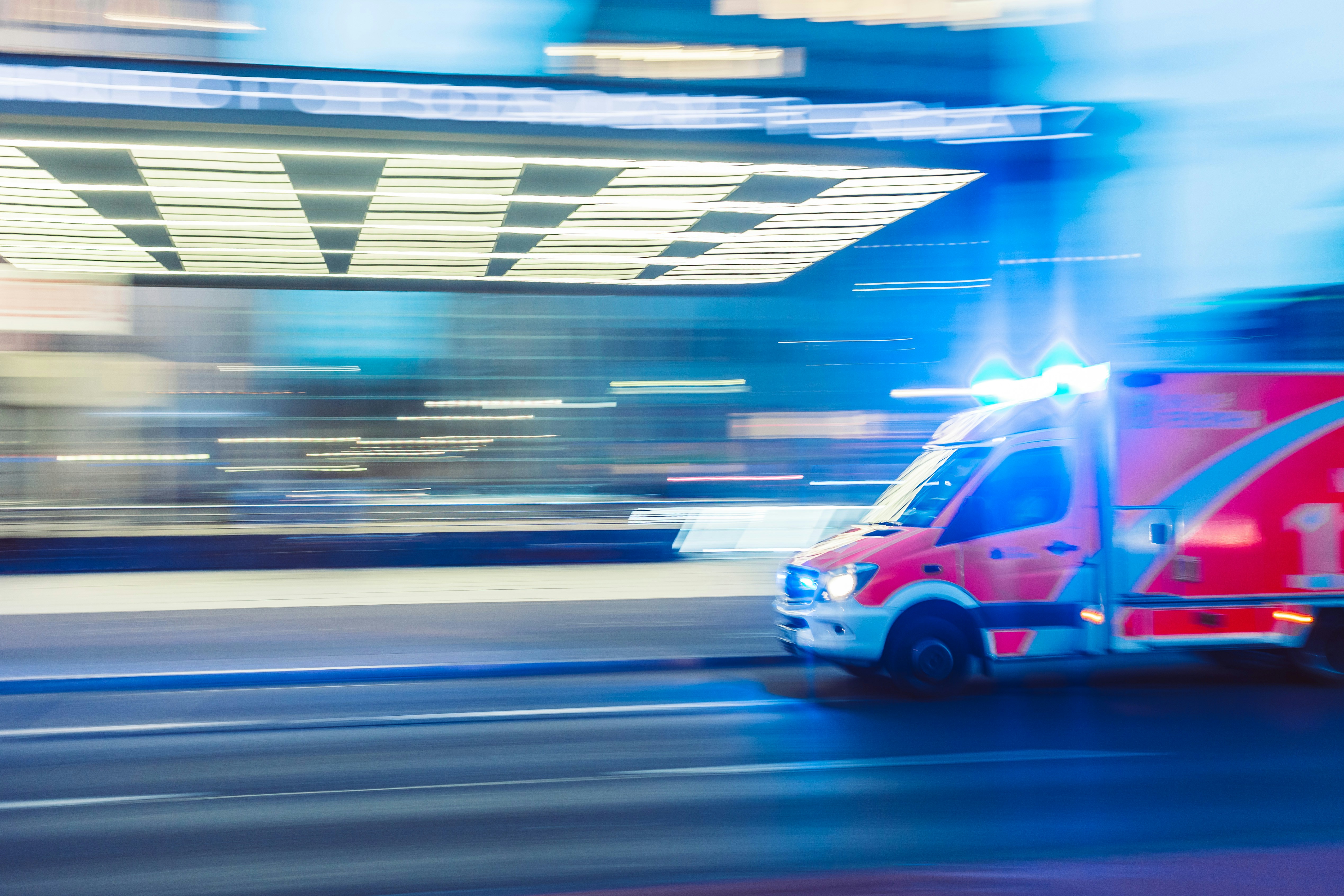 blurred motion image of emergency vehicle in lighted tunnel