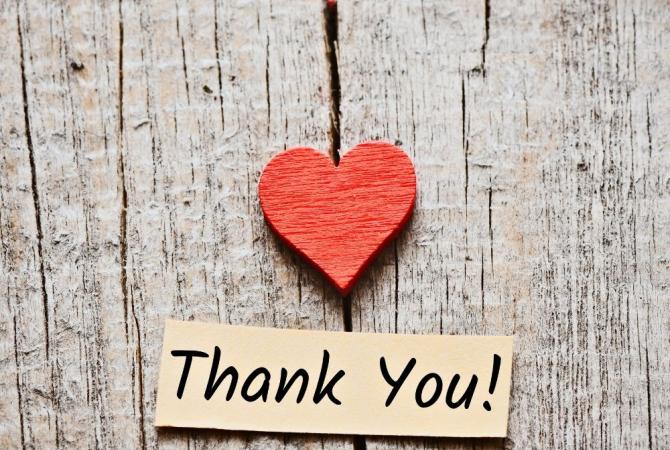 weathered board with red heart and text saying Thank You